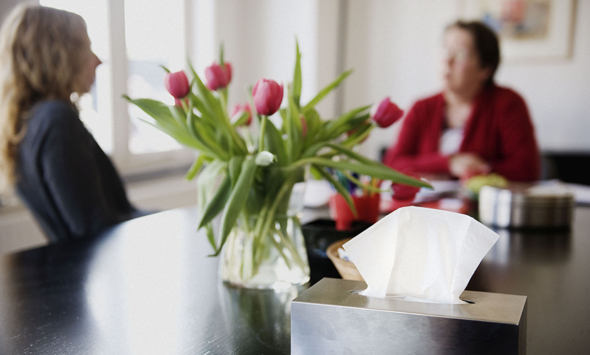 Twee dames in gesprek met op de voorgrond een tissue box